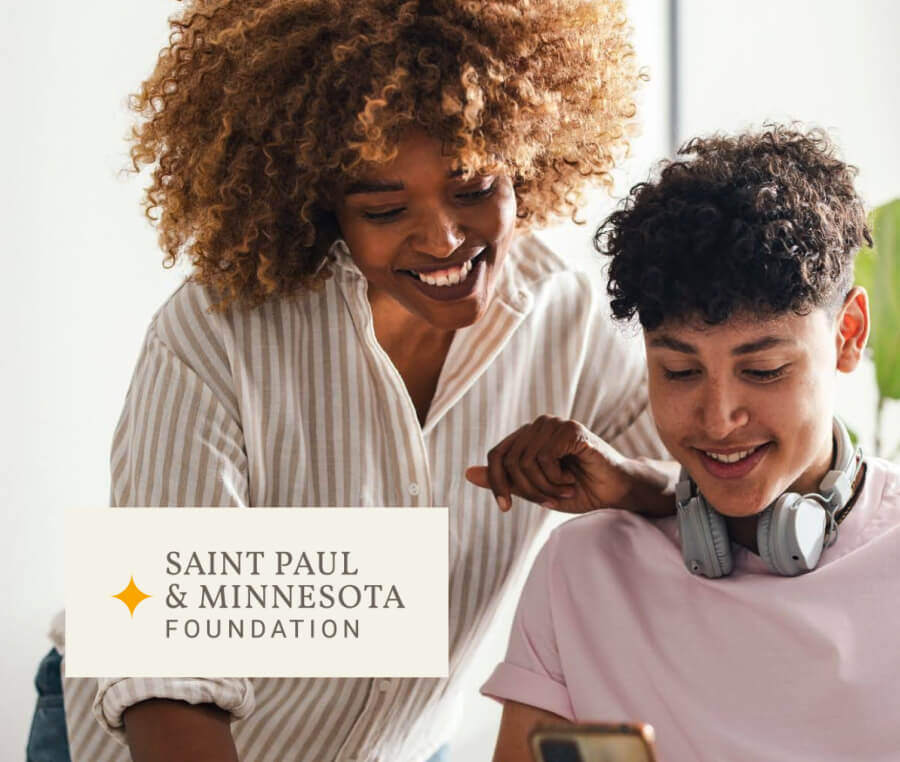 Cover image of two colleagues smiling and looking down at a phone